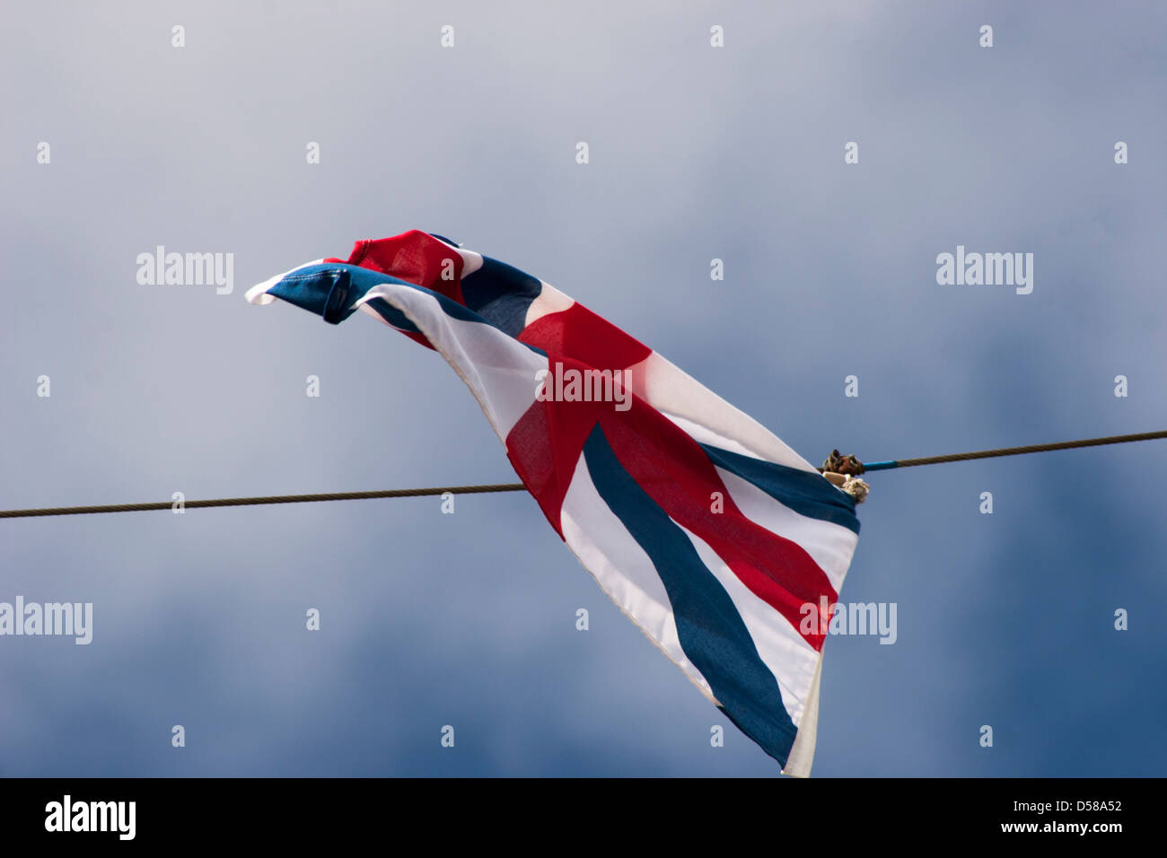 Union jack flag waving in the wind with blue sky background Stock Photo ...