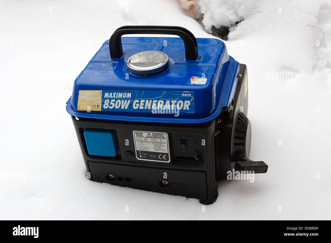 small emergency backup petrol electricity generator in heavy winter snowstorm newtownabbey uk Stock Photo