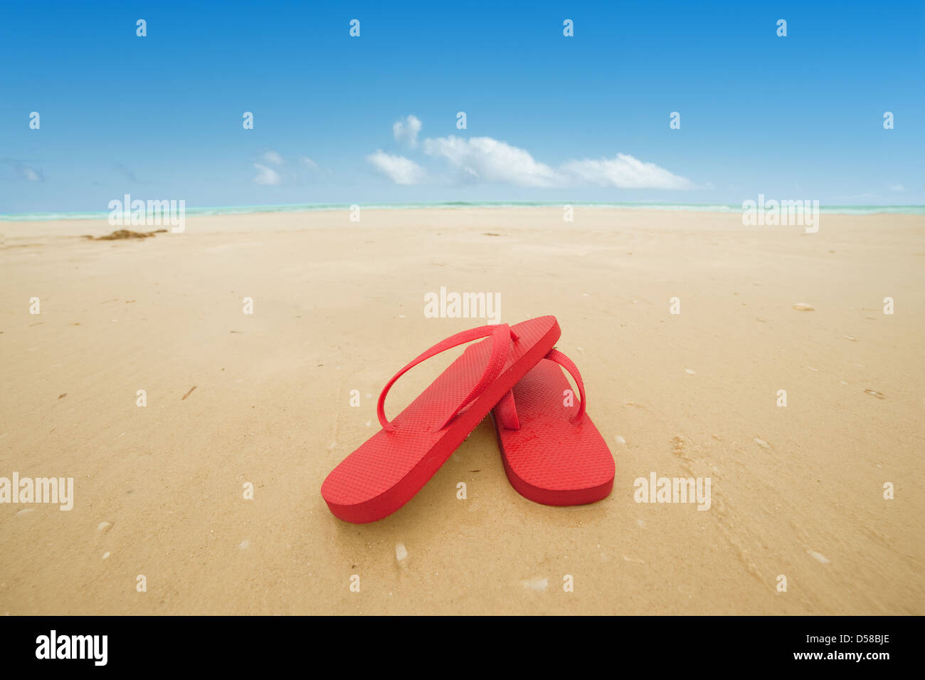 Red flip flops on the beach sand.Concept of summer vacations Stock ...