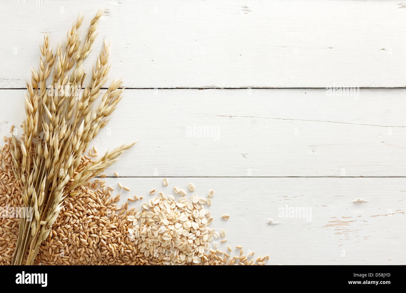 oats with its processed and unprocessed grains against white wood background Stock Photo