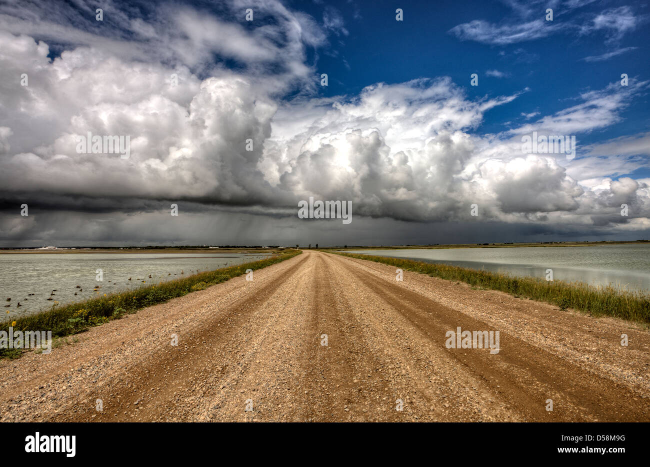 Storm Clouds Saskatchewan billowing clouds and gravel road Stock Photo ...