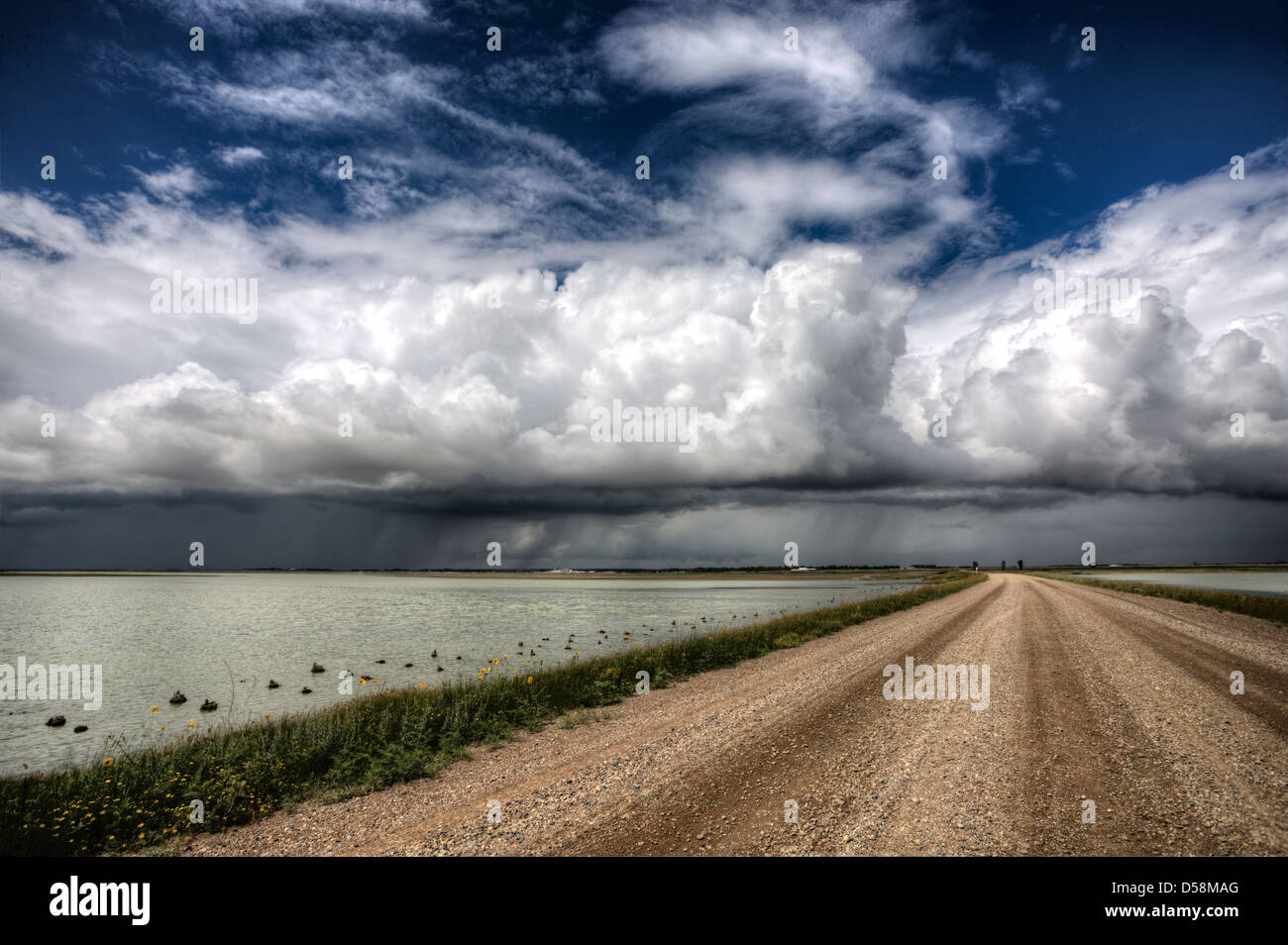Storm Clouds Saskatchewan billowing clouds and gravel road Stock Photo ...