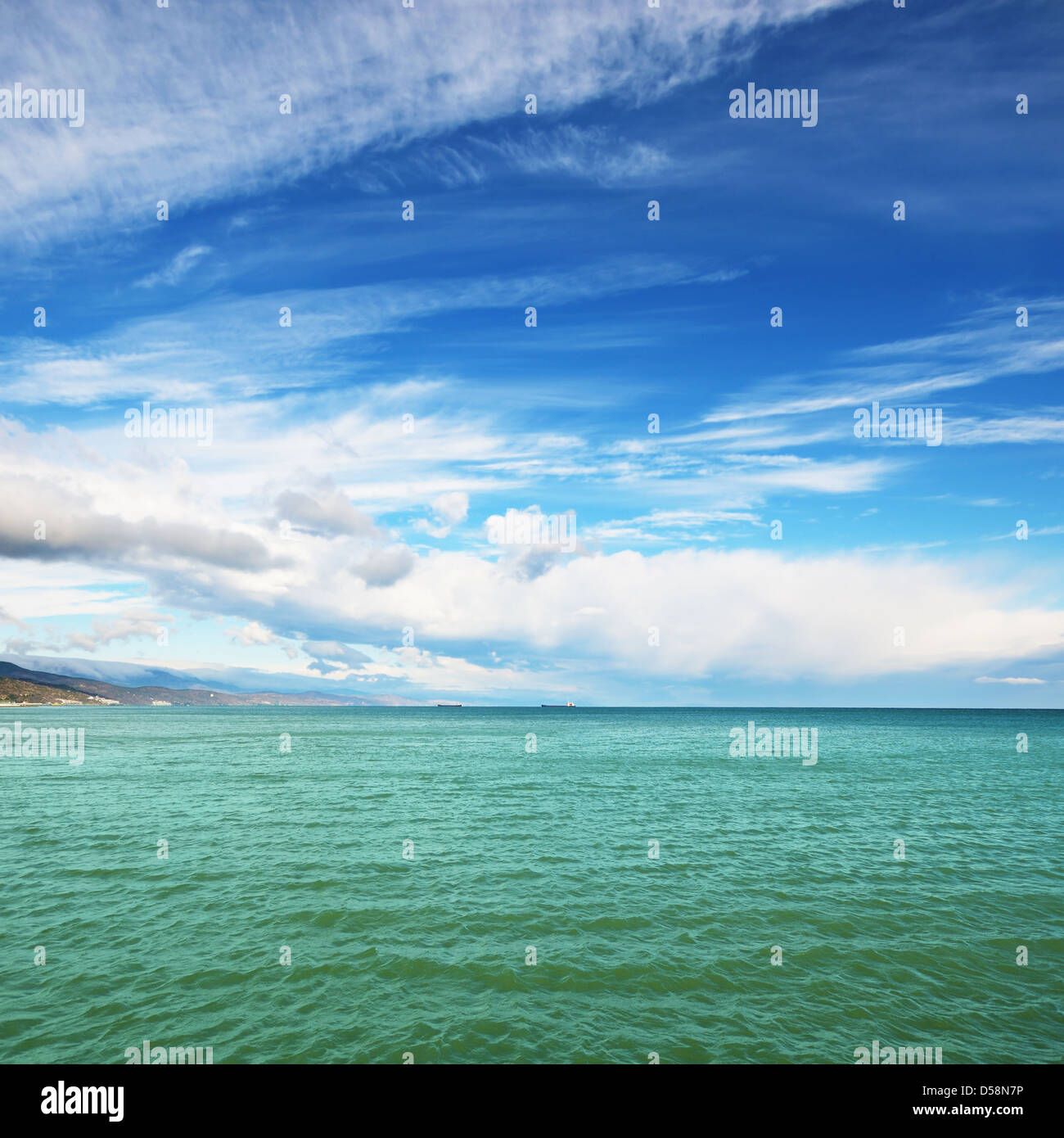 Sea under blue cloudy sky Stock Photo - Alamy