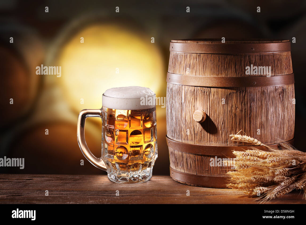 Beer glasses with a wooden barrel. Background - dark yellow gradient. Stock Photo