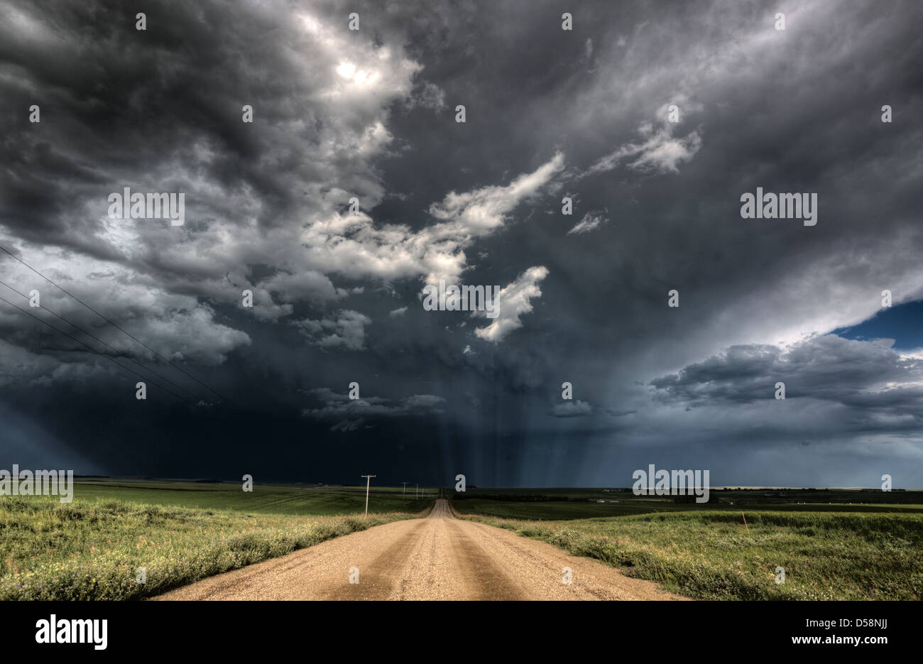 Storm Clouds Saskatchewan billowing clouds and gravel road Stock Photo ...