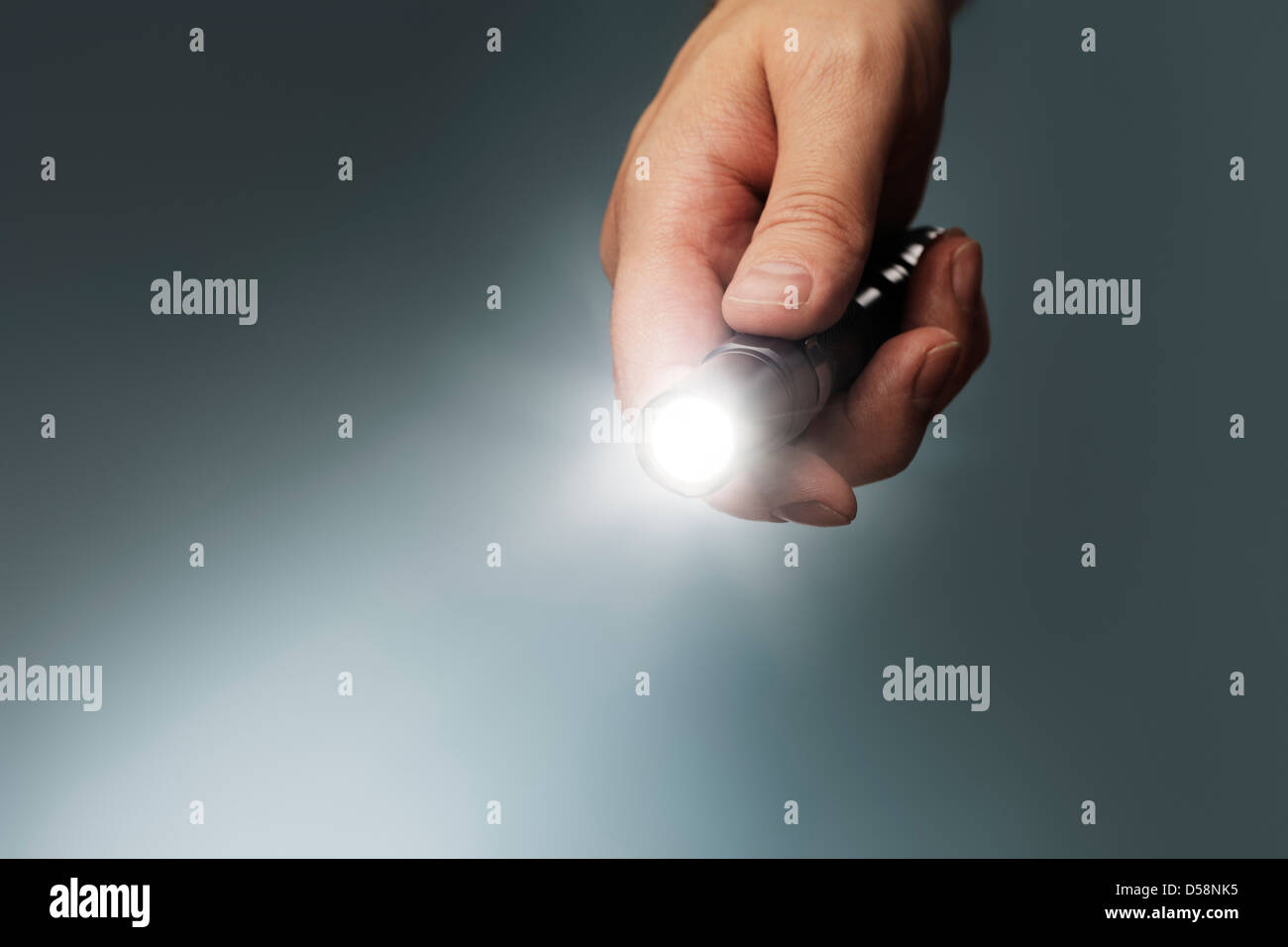 Man Holding A Small But Powerful Led Flashlight In His Hand Stock Photo Alamy