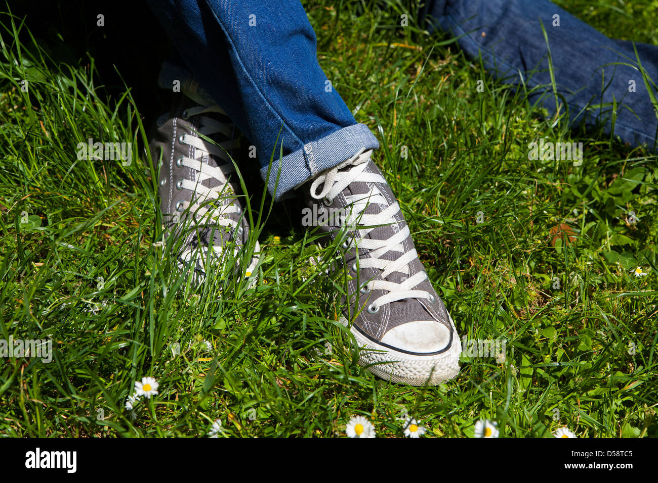 Youth relaxing on a grass field Stock Photo