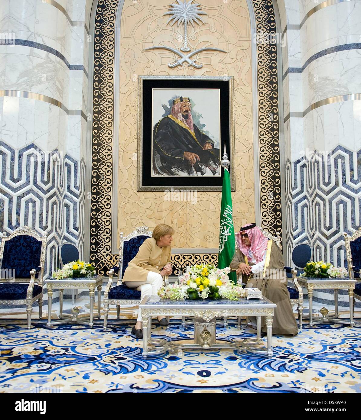 German Chancellor Angela Merkel talks with Saudi Arabia's Foreign Minister Prince Saud Al Faisal bin Abdulaziz Al Saud at airport in Jeddah, Saudi Arabia, 25 May 2010. On the motive in the backround is founder king Abdulaziz Al Saud. Merkel will visit four of six Gulf Cooperation Council countries until 27 May 2010 to improve economic and political ties. Photo: BUNDESREGIERUNG / BE Stock Photo
