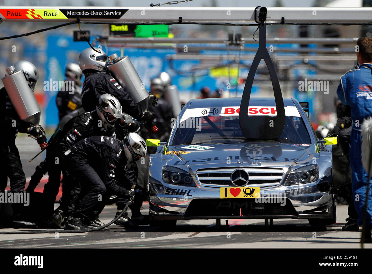 The pit crew refuels the race car of German driver Ralf Schumacher of ...