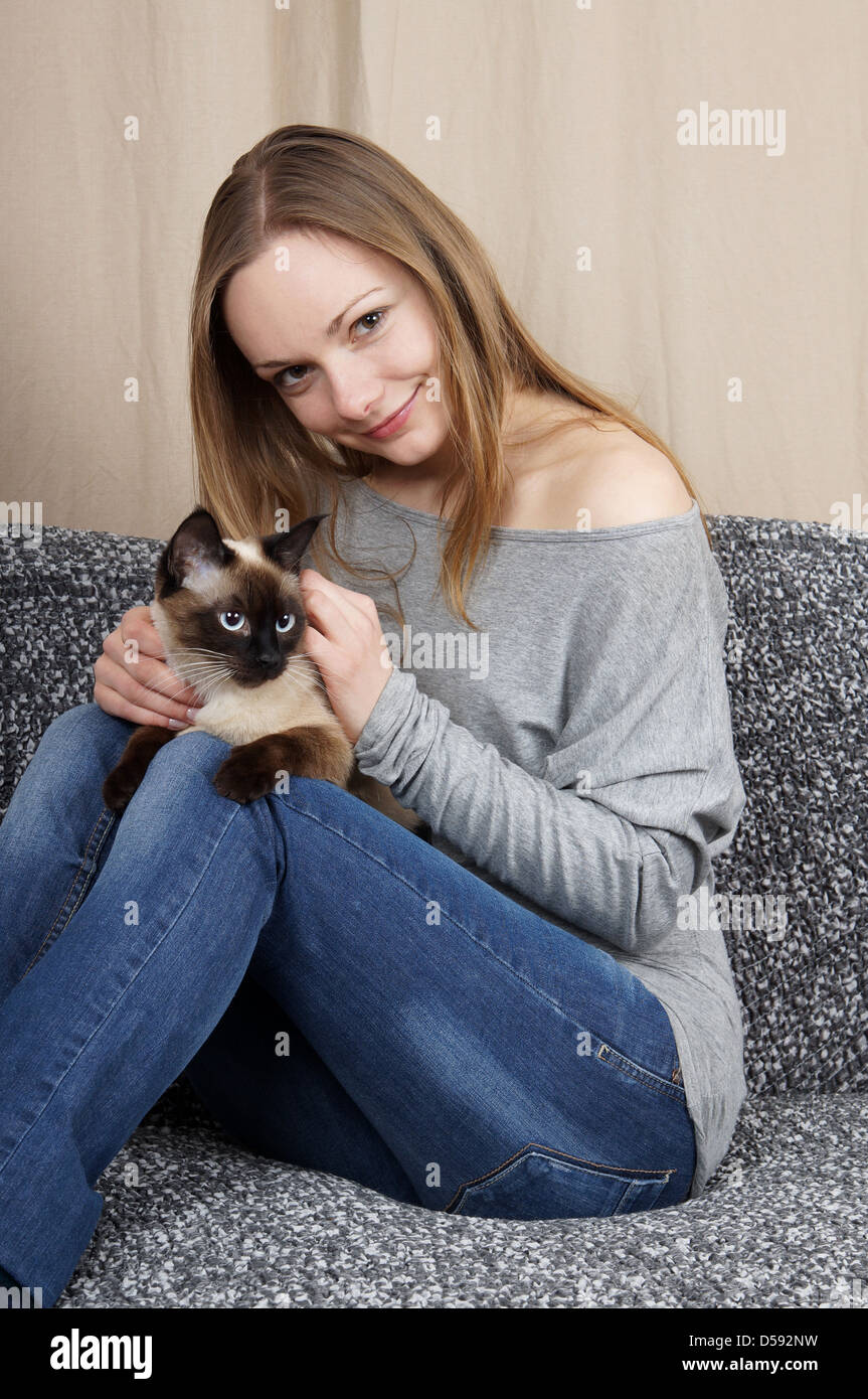 happy young woman with siamese cat Stock Photo Alamy