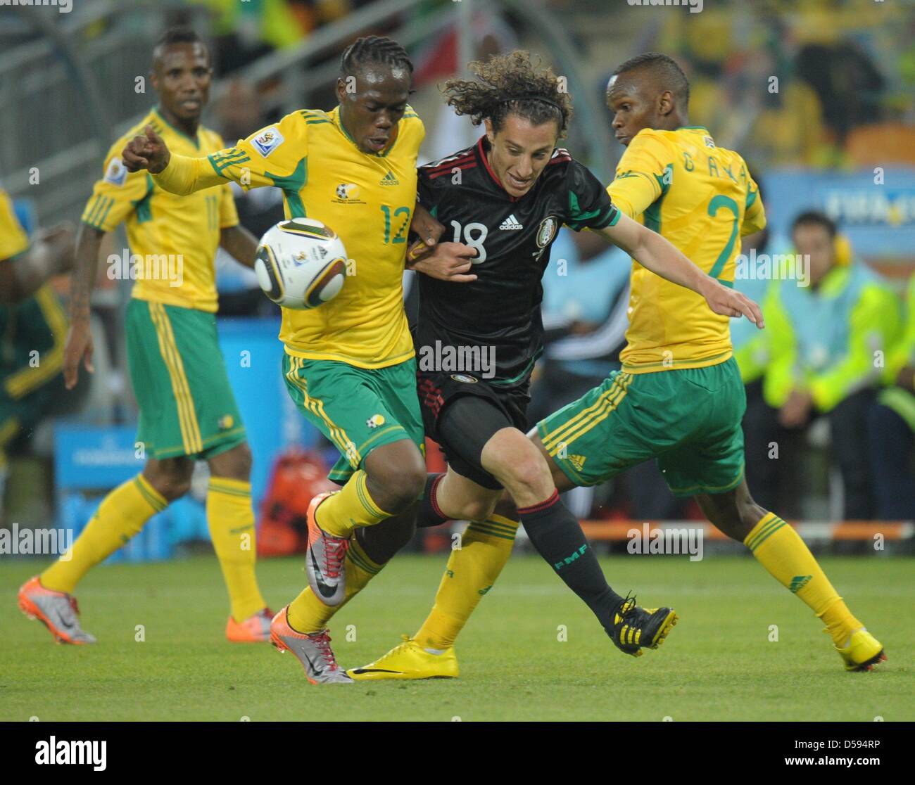 Reneilwe Letsholonyane (L) and Siboniso Gaxa (R) of South Africa vies with Andres Guardado (C) of Mexico during the 2010 FIFA World Cup opening match at Soccer City stadium in Johannesburg, South Africa 11 June 2010. Photo: Roland Wittek dpa Please refer to http://dpaq.de/FIFA-WM2010-TC  +++(c) dpa - Bildfunk+++ Stock Photo