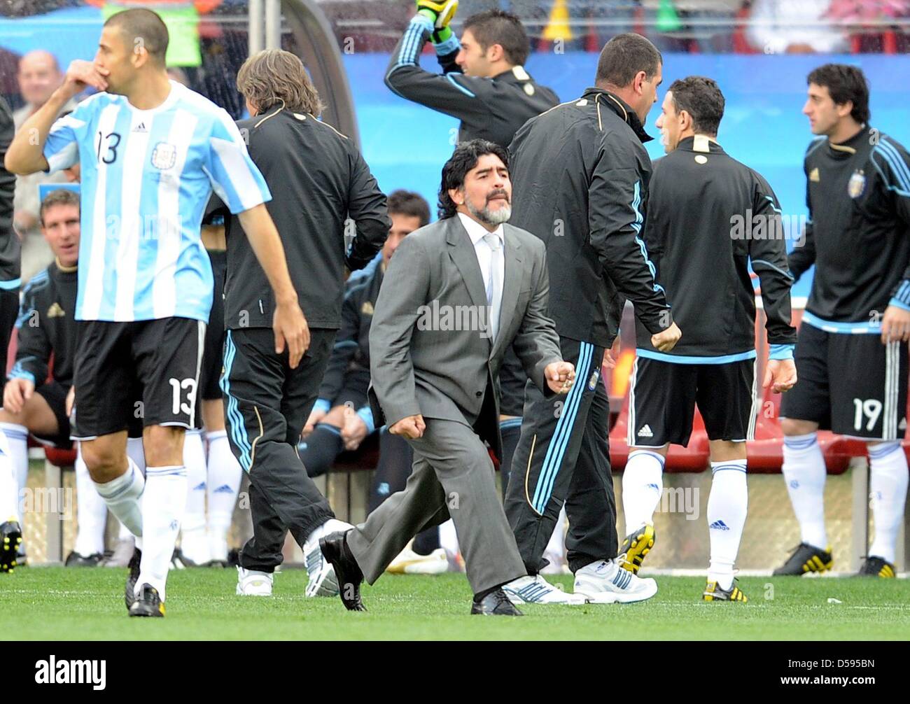 Argentina's coach Diego Armando Maradona celebrates at the sideline during the 2010 FIFA World Cup group B match between Argentina and Nigeria at Ellis Park stadium in Johannesburg, South Africa 12 June 2010. At right Argentina's Lionel Messi. Photo: Achim Scheidemann - Please refer to http://dpaq.de/FIFA-WM2010-TC  +++(c) dpa - Bildfunk+++ Stock Photo