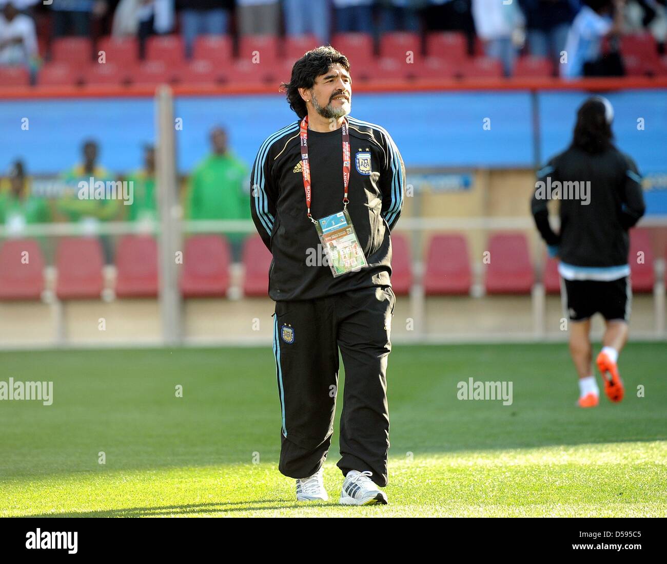 Argentina's coach Diego Armando Maradona walks over the pitch prior to the 2010 FIFA World Cup group B match between Argentina and Nigeria at Ellis Park stadium in Johannesburg, South Africa 12 June 2010. At right Argentina's Lionel Messi. Photo: Achim Scheidemann - Please refer to http://dpaq.de/FIFA-WM2010-TC Stock Photo