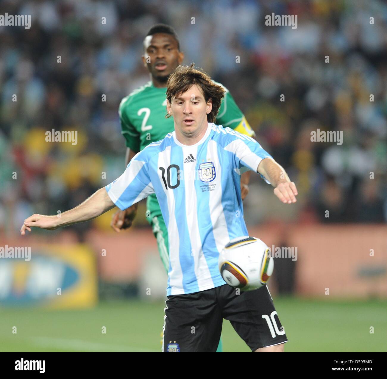 Argentina's Lionel Messi (front) vies for the ball with Nigeria's Joseph Yobo during the 2010 FIFA World Cup group B match between Argentina and Nigeria at Ellis Park stadium in Johannesburg, South Africa 12 June 2010. Argentina won 1-0. Photo: Achim Scheidemann - Please refer to http://dpaq.de/FIFA-WM2010-TC Stock Photo