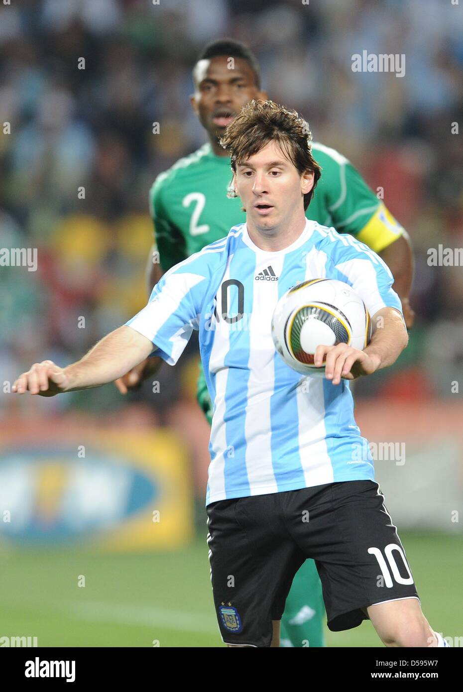 Nigiera's Joseph Yobo vies for the ball with Argentina's Lionel Messi (front) during the 2010 FIFA World Cup group B match between Argentina and Nigeria at Ellis Park stadium in Johannesburg, South Africa 12 June 2010. Argentina won 1-0. Photo: Achim Scheidemann - Please refer to http://dpaq.de/FIFA-WM2010-TC Stock Photo