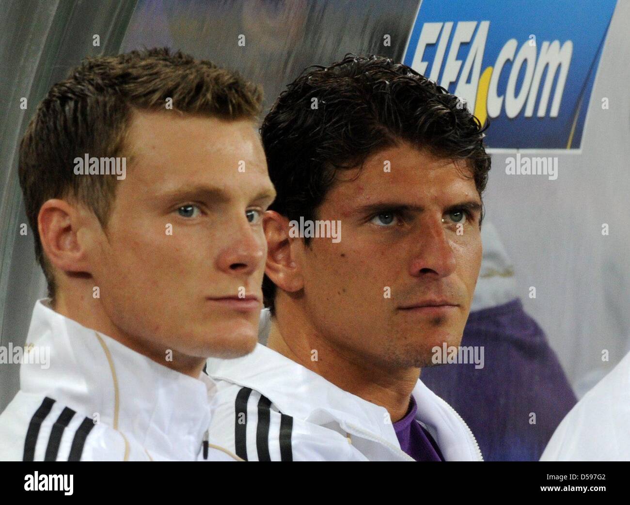 Germany's substitute player Marcell Jansen (L) and Mario Gomez sit on the bench during the 2010 FIFA World Cup group D match between Germany and Australia at Durban Stadium in Durban, South Africa 13 June 2010. Germany won 4-0. Photo: Marcus Brandt dpa - Please refer to http://dpaq.de/FIFA-WM2010-TC Stock Photo