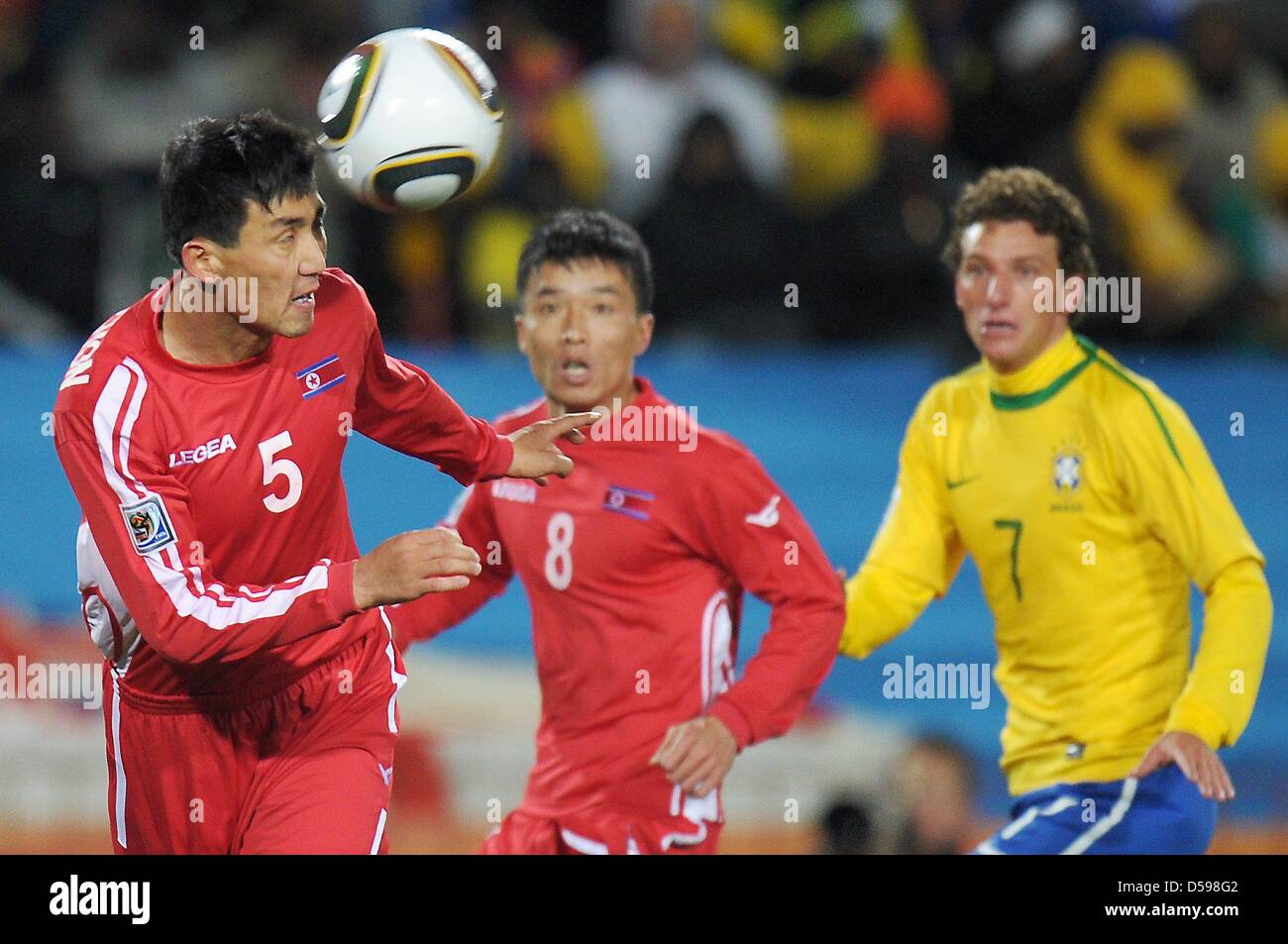 Elano (R) of Brazil vies with Ri Kwang Chon (L) and Ji Yun Nam of North Korea during the FIFA World Cup 2010 group G match between Brazil and North Korea at Ellis Park Stadium in Johannesburg, South Africa 15 June 2010. Photo: Ronald Wittek dpa - Please refer to http://dpaq.de/FIFA-WM2010-TC  +++(c) dpa - Bildfunk+++ Stock Photo