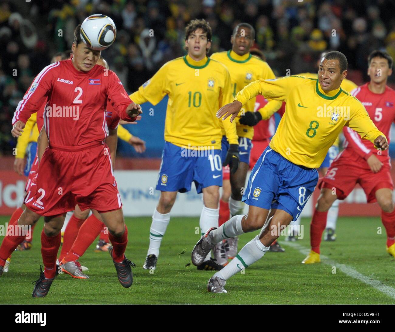 Gilberto Silva (R) of Brazil vies with Cha Jong-Hyok (L) of North Korea during the FIFA World Cup 2010 group G match between Brazil and North Korea at Ellis Park Stadium in Johannesburg, South Africa 15 June 2010. Photo: Ronald Wittek dpa - Please refer to http://dpaq.de/FIFA-WM2010-TC  +++(c) dpa - Bildfunk+++ Stock Photo