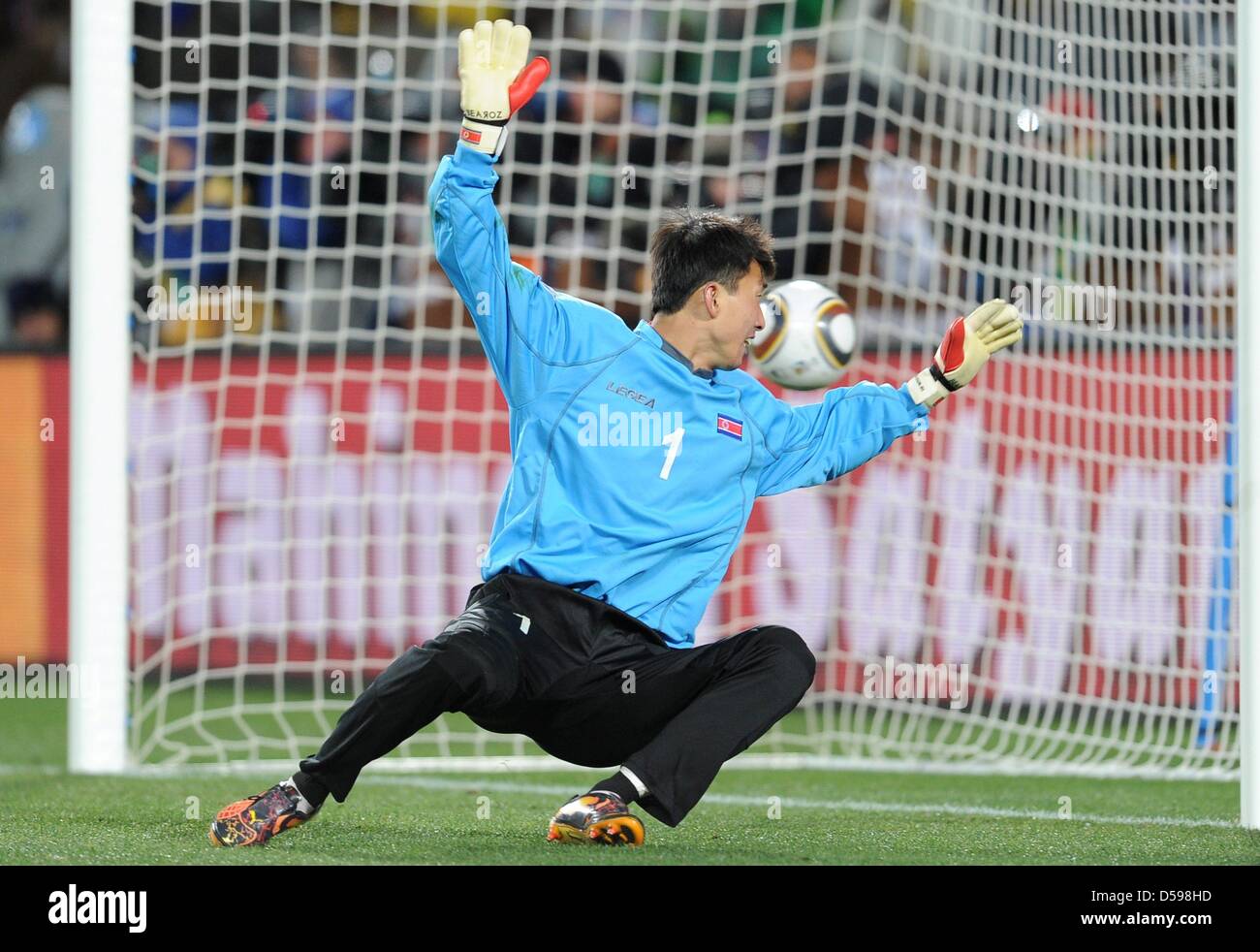 Korea's goalkeeper Ri Myong Guk is unable to save the ball during the