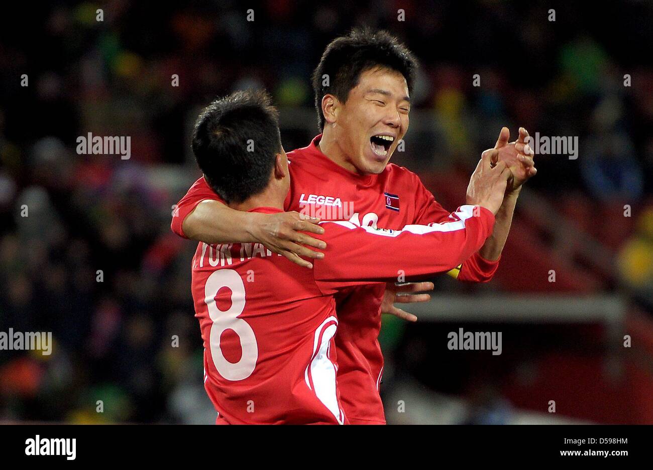 Ji Yun Nam (L) of North Korea celebrates with Hong Yong Jo after scoring during the FIFA World Cup 2010 group G match between Brazil and North Korea at Ellis Park Stadium in Johannesburg, South Africa 15 June 2010. Photo: Ronald Wittek dpa - Please refer to http://dpaq.de/FIFA-WM2010-TC  +++(c) dpa - Bildfunk+++ Stock Photo