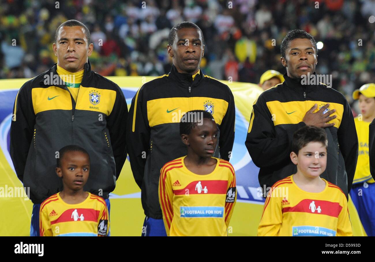 Brazilian Gilberto Silva (L-R), Juan and Michel Bastos listen to the national anthem prior to the 2010 FIFA World Cup group G match between Brazil and North Korea at Ellis Park stadium in Johannesburg, South Africa 15 June 2010. Photo: Achim Scheidemann - Please refer to http://dpaq.de/FIFA-WM2010-TC Stock Photo