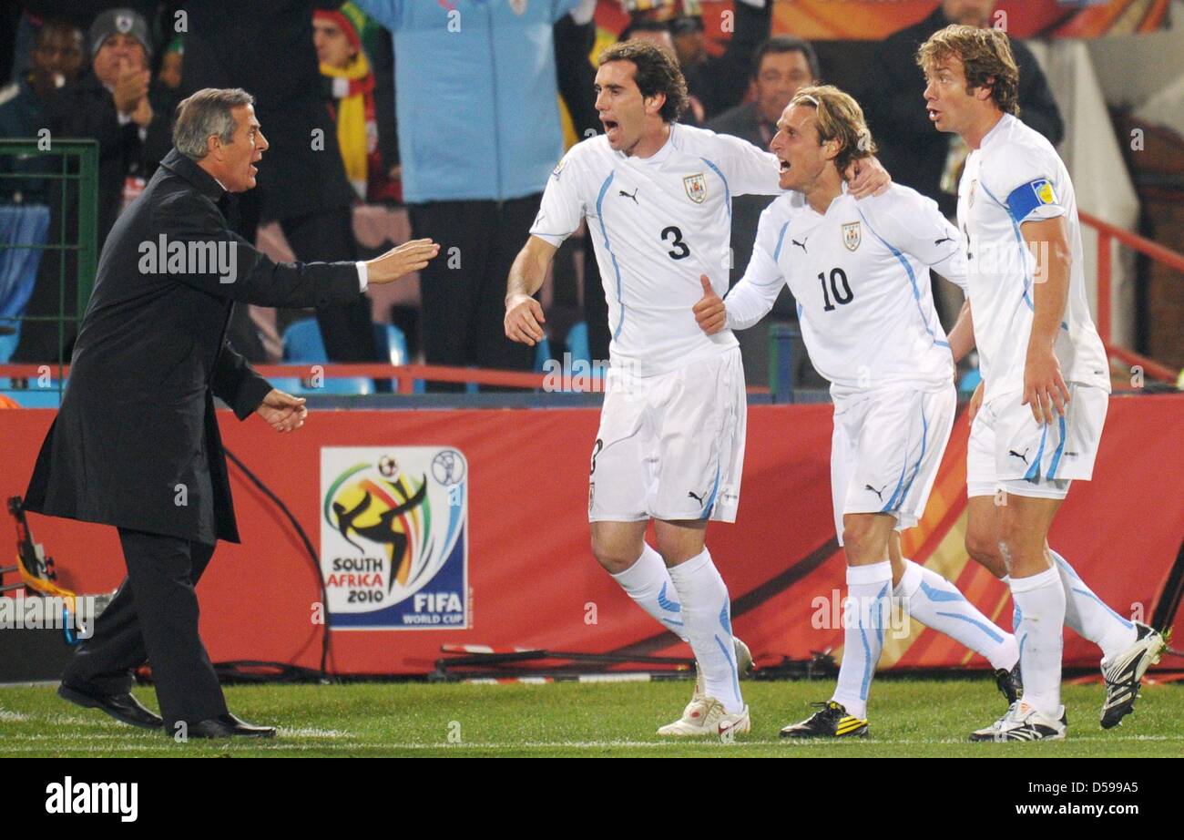Diego Forlan (2-R) of Uruguay celebrates with headcoach Oscar Tabarez (L) and his teammates Diego Godin (C) and Diego Lugano after scoring the 1-0 during the FIFA World Cup 2010 group A match between South Africa and Uruguay at Loftus Versfeld Stadium in Pretoria, South Africa 16 June 2010. Photo: Ronald Wittek dpa - Please refer to http://dpaq.de/FIFA-WM2010-TC  +++(c) dpa - Bildf Stock Photo