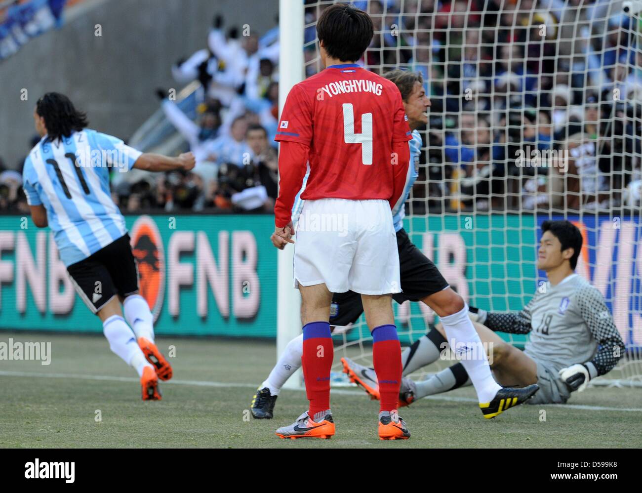 Argentina's Gabriel Heinze (C, hidden) and Carlos Tevez celebrate the 1-0 by own goal as South Korea's goalkeeper Jung Sung Ryong sits beaten on the ground during the 2010 FIFA World Cup group B match between Argentina and South Korea at Soccer City Stadium in Johannesburg, South Africa 17 June 2010. Photo: Achim Scheidemann - Please refer to http://dpaq.de/FIFA-WM2010-TC  +++(c) d Stock Photo
