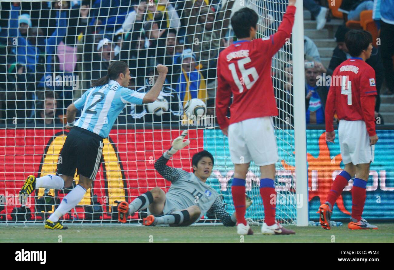 Martin Demichelis (L) of Argentina celebrates after Higuain scored the 2-0 while goalkeeper Jung Sung Ryong (2-L) of South Korea lies on the ground during the FIFA World Cup 2010 group B match between Argentina and South Korea at Soccer City Stadium in Johannesburg, South Africa 17 June 2010. Photo: Ronald Wittek dpa - Please refer to http://dpaq.de/FIFA-WM2010-TC  +++(c) dpa - Bil Stock Photo