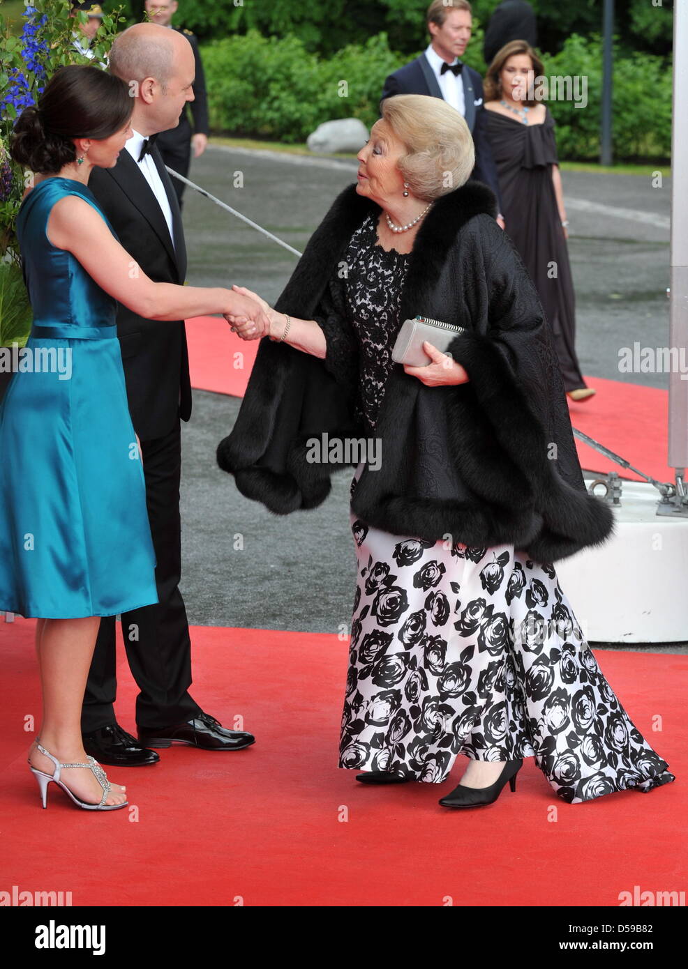 Queen Beatrix of the Netherlands (R) is welcomed by Swedish Prime Minister Fredrik Reinfeldt and his wife Filippa for the goverment dinner held at the Eric Ericson Hall on Skeppsholmen, one of the islands of Stockholm, on the occasion of the wedding of Crown Princess Victoria of Sweden and Daniel Westling in Stockholm, Sweden, 18 June 2010. The royal wedding ceremony of Crown Princ Stock Photo