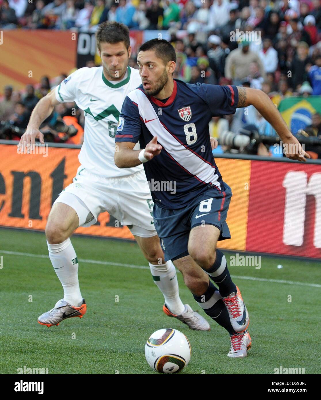 Bostjan Cesar of Slovenia (L) vies with Clint Dempsey of the USA during the FIFA World Cup 2010 group C match between Slovenia and USA at the Ellis Park Stadium in Johannesburg, South Africa 18 June 2010. Photo: Ronald Wittek dpa - Please refer to http://dpaq.de/FIFA-WM2010-TC Stock Photo