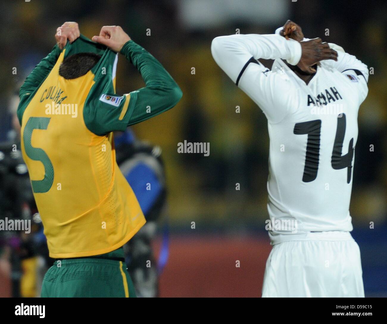 Australia's Jason Culina (L) changes his jersey with Ghana's Matthew Amoah  after the 2010 FIFA World Cup group D match between Ghana and Australia at  the Royal Bafokeng Stadium in Rustenburg, South
