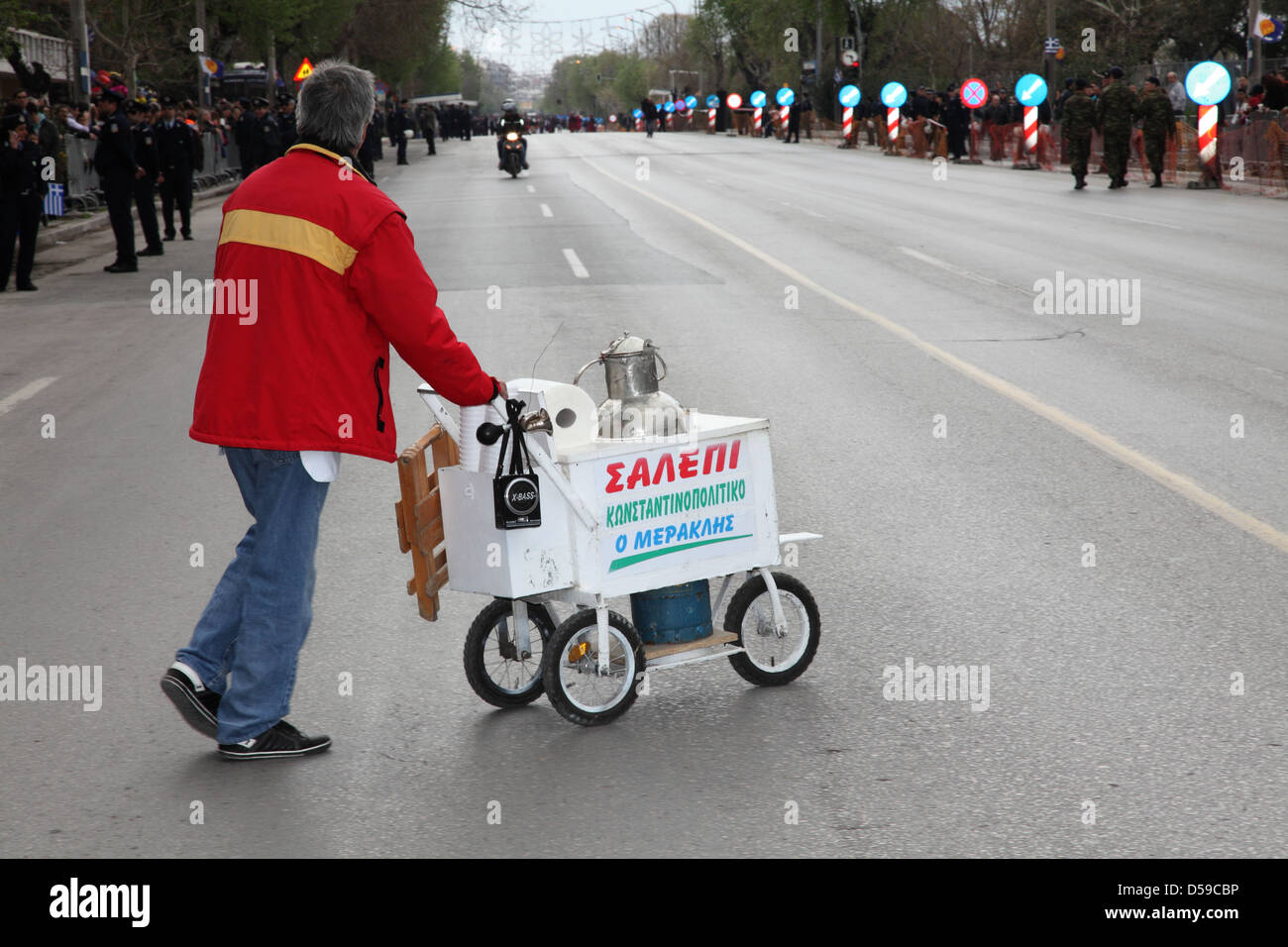 a salep itinerant salesman,crossing the street,before a parade start Stock Photo