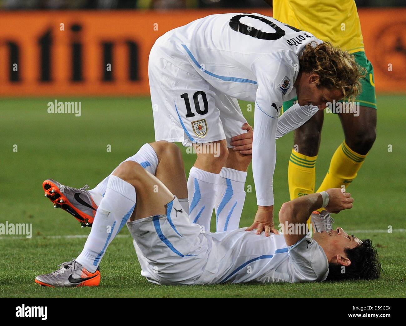Uruguay's Jorge Fucile lies injured on the ground during the 2010 FIFA World Cup group A match between South Africa and Uruguay at Loftus Versfeld Stadium in Pretoria, South Africa 16 June 2010. Photo: Achim Scheidemann - Please refer to http://dpaq.de/FIFA-WM2010-TC Stock Photo