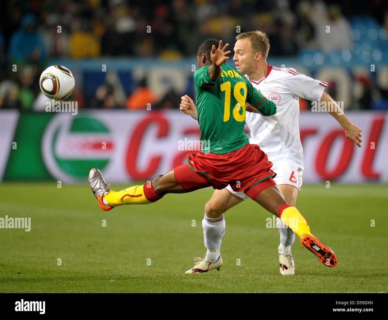 Eyong Enoh (L) of Cameroon vies with Lars Jacobsen of Denmark during the FIFA World Cup 2010 group E match between Cameroon and Denmark at Loftus Versfeld Stadium in Pretoria, South Africa 19 June 2010. Photo: Ronald Wittek dpa - Please refer to http://dpaq.de/FIFA-WM2010-TC Stock Photo