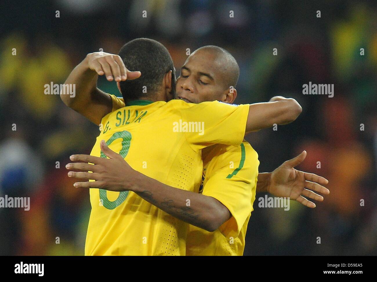 Gilberto Silva (L) and Maicon of Brazil celebrate after the final whistle of the FIFA World Cup 2010 group G match between Brazil and Ivory Coast at the Soccer City Stadium in Johannesburg, South Africa 20 June 2010. Photo: Ronald Wittek dpa - Please refer to http://dpaq.de/FIFA-WM2010-TC  +++(c) dpa - Bildfunk+++ Stock Photo