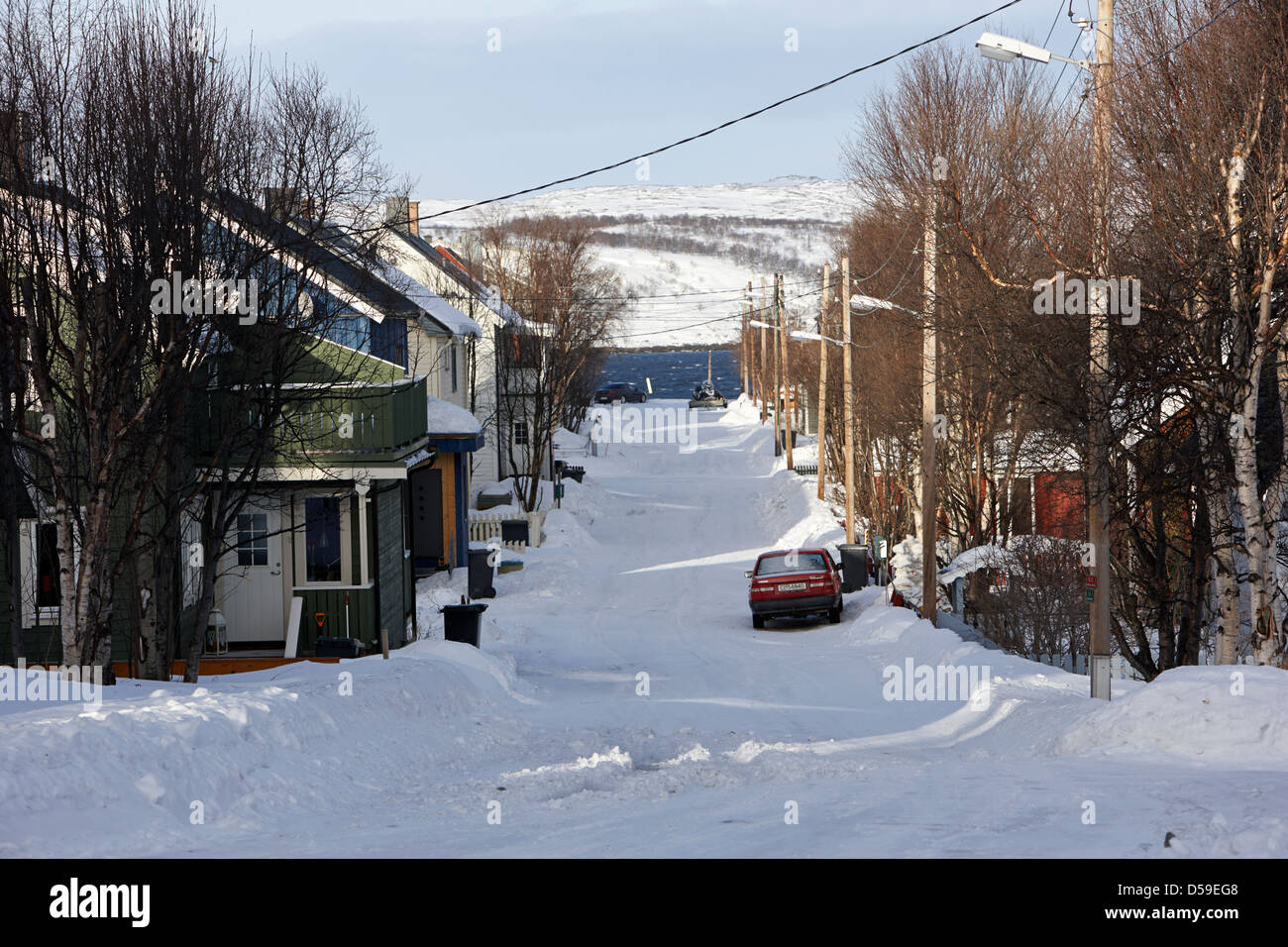 snow covered street of traditional wooden houses in kirkenes finnmark