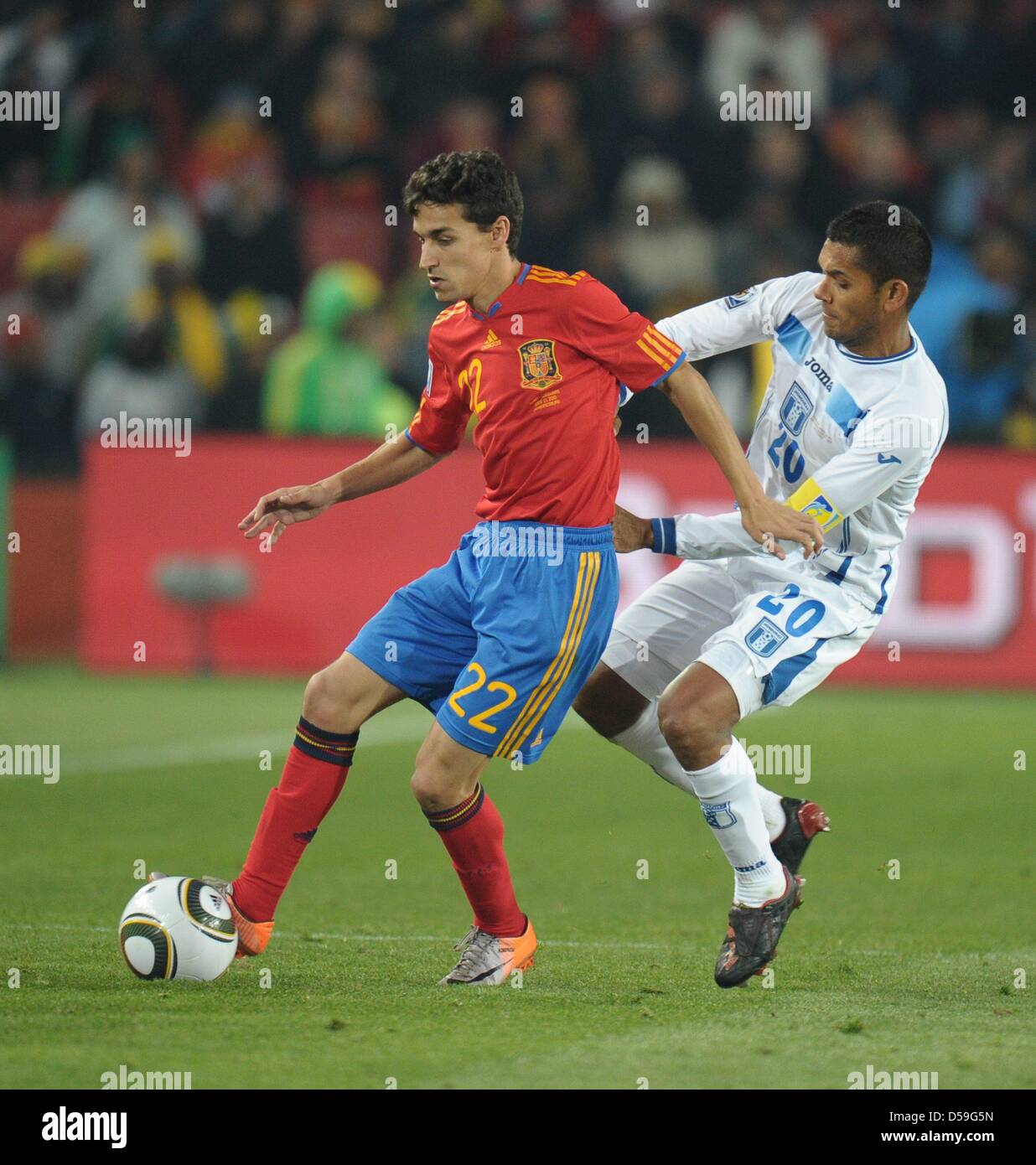 Jesus Navas (L) of Spain vies with Amado Guevara of Honduras during the FIFA World Cup 2010 group H match between Spain and Honduras at the Ellis Park Stadium in Johannesburg, South Africa 21 June 2010. Photo: Ronald Wittek dpa - Please refer to http://dpaq.de/FIFA-WM2010-TC Stock Photo