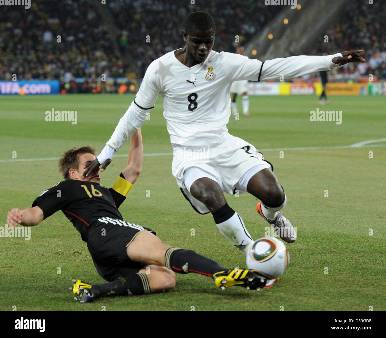 Germany's Philipp Lahm (L) and Ghana's Jonathan Mensah vie for the ball during the 2010 FIFA World Cup group D match between Ghana and Germany at Soccer City, Johannesburg, South Africa 23 June 2010. Photo: Marcus Brandt dpa - Please refer to http://dpaq.de/FIFA-WM2010-TC Stock Photo