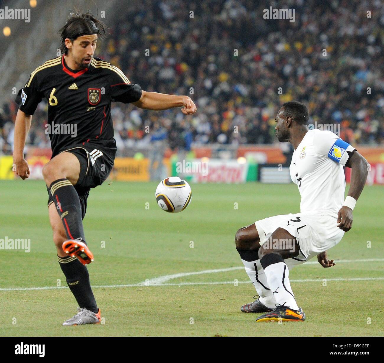 Germany's Sami Khedira (L) vies with Ghana's John Mensah during the 2010 FIFA World Cup group D match between Ghana and Germany at Soccer City, Johannesburg, South Africa 23 June 2010. Photo: Marcus Brandt dpa - Please refer to http://dpaq.de/FIFA-WM2010-TC  +++(c) dpa - Bildfunk+++ Stock Photo