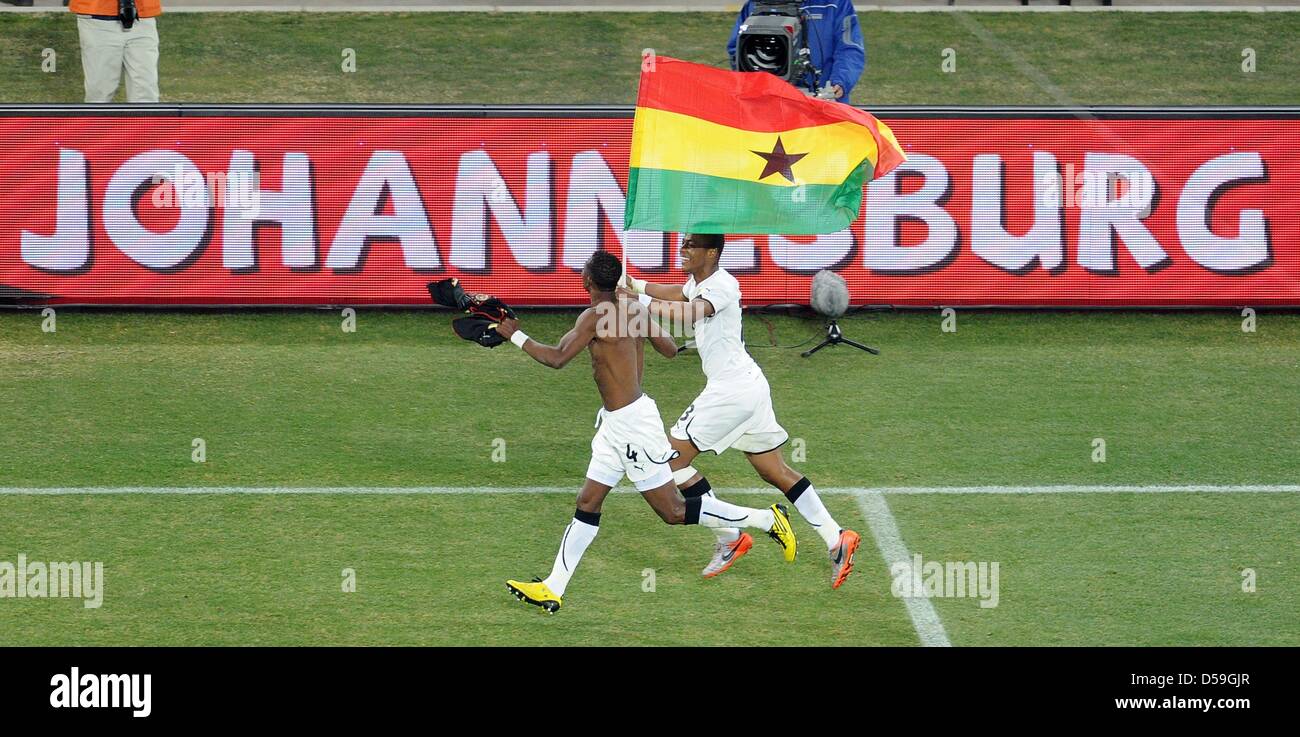 Ghana s John Pantsil L and Andre Ayew celebrate with the team s national flag after the 2010 FIFA World Cup group D match between Ghana and Germany at Soccer City Johannesburg South Africa