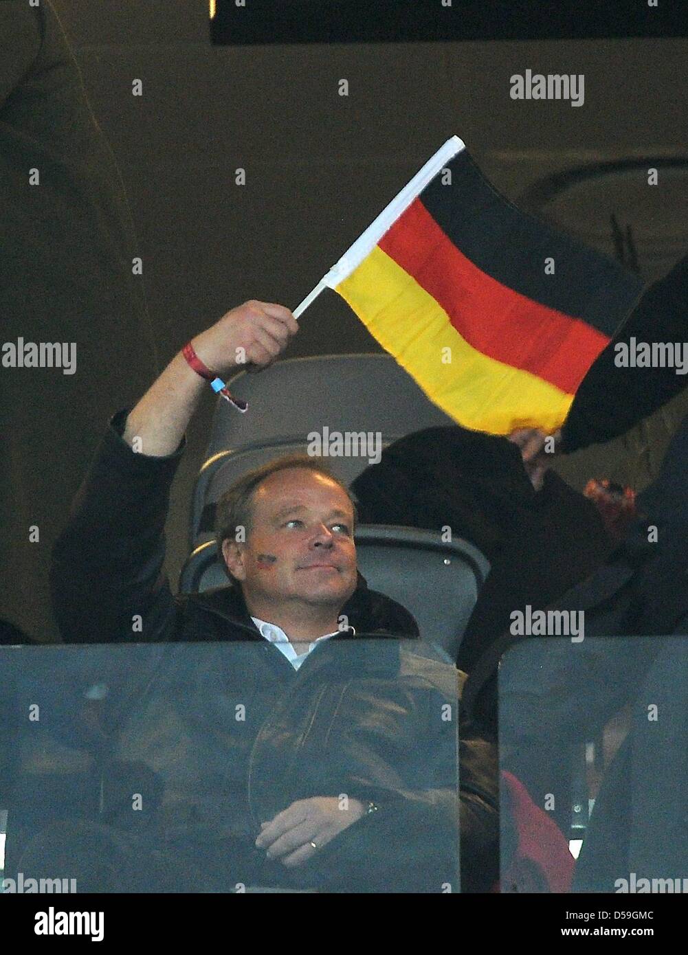 Dirk Niebel (FDP), German Federal Minister of Economic Cooperation and Development, waves a German flag during the 2010 FIFA World Cup group D match between Ghana and Germany at Soccer City, Johannesburg, South Africa 23 June 2010. Photo: Marcus Brandt dpa - Please refer to http://dpaq.de/FIFA-WM2010-TC Stock Photo