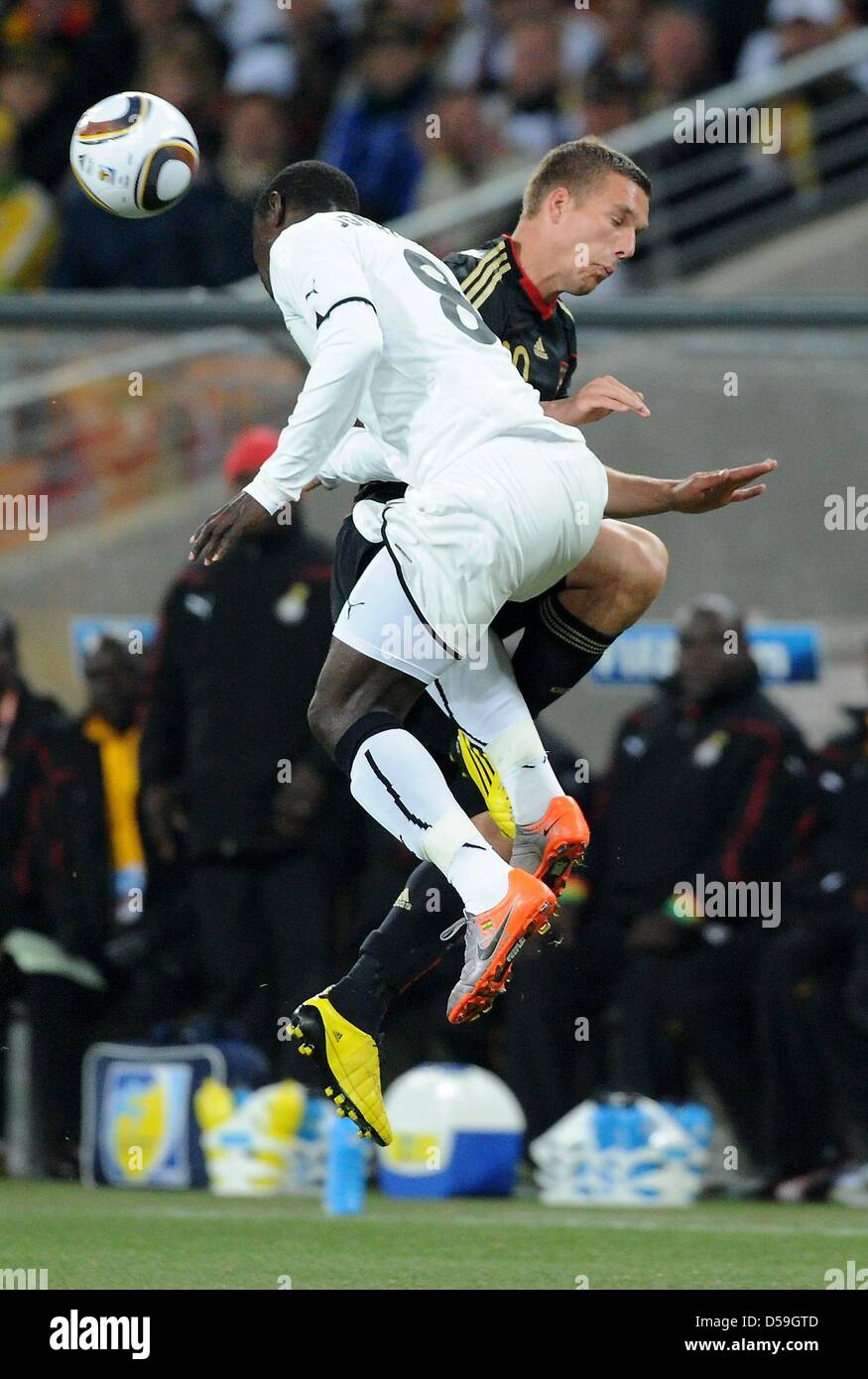 Germany's Lukas Podolski and Ghana's Jonathan Mensah vie for the ball during the 2010 FIFA World Cup group D match between Ghana and Germany at Soccer City, Johannesburg, South Africa 23 June 2010. Photo: Marcus Brandt dpa - Please refer to http://dpaq.de/FIFA-WM2010-TC Stock Photo