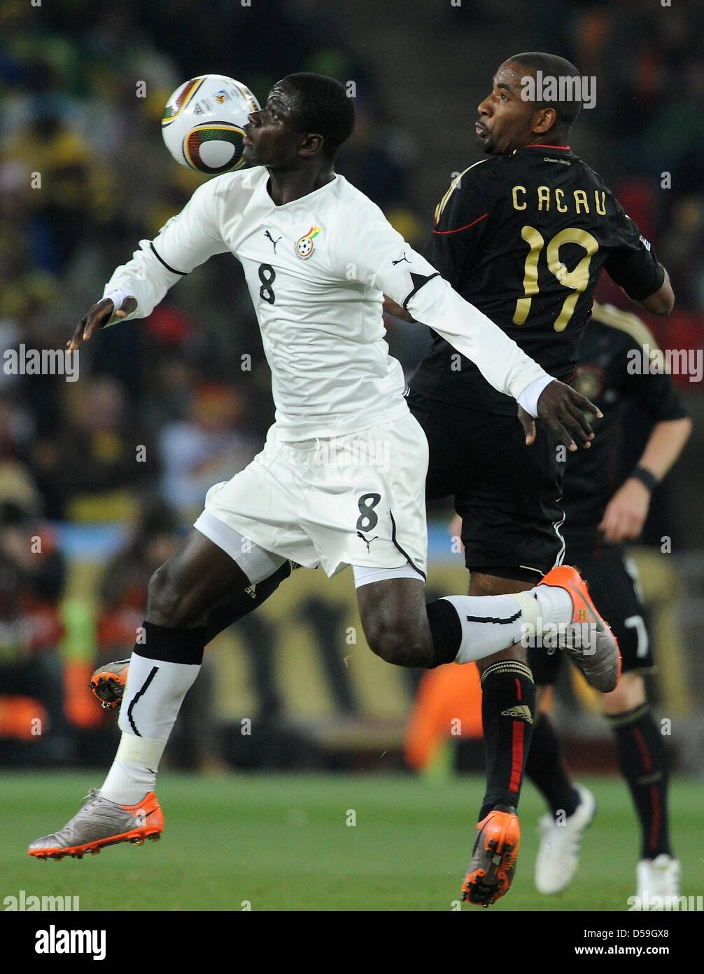 Germany's Cacau (R) and Ghana's Jonathan Mensah vie for the ball during the 2010 FIFA World Cup group D match between Ghana and Germany at Soccer City, Johannesburg, South Africa 23 June 2010. Photo: Marcus Brandt dpa - Please refer to http://dpaq.de/FIFA-WM2010-TC Stock Photo