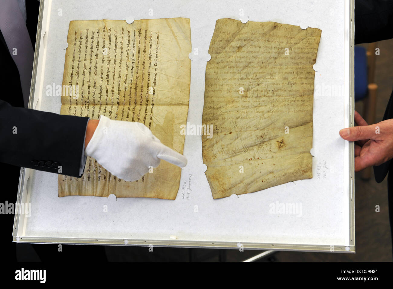 A hand points on the eldest preserved document issued by a knig in Marburg, Germany, 23 June 2010. The pergament was issued in 1250 AD by Carolingian King Pippn III, father of Charlemagne. In the document, Pippin III donates a large amount to the cloister of Fulda. Photo: Uwe Zucchi Stock Photo