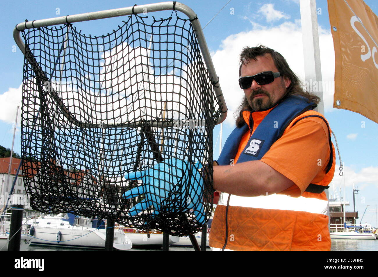 (L-R) Boatmen Stephan Zerbs, Reinhard Sturm and Heiko Lutz ride on garbage collector boat 'Schiermoker II' in Kiel, Germany, 23 June 2010. Photo: Maurizio Gambarini Stock Photo