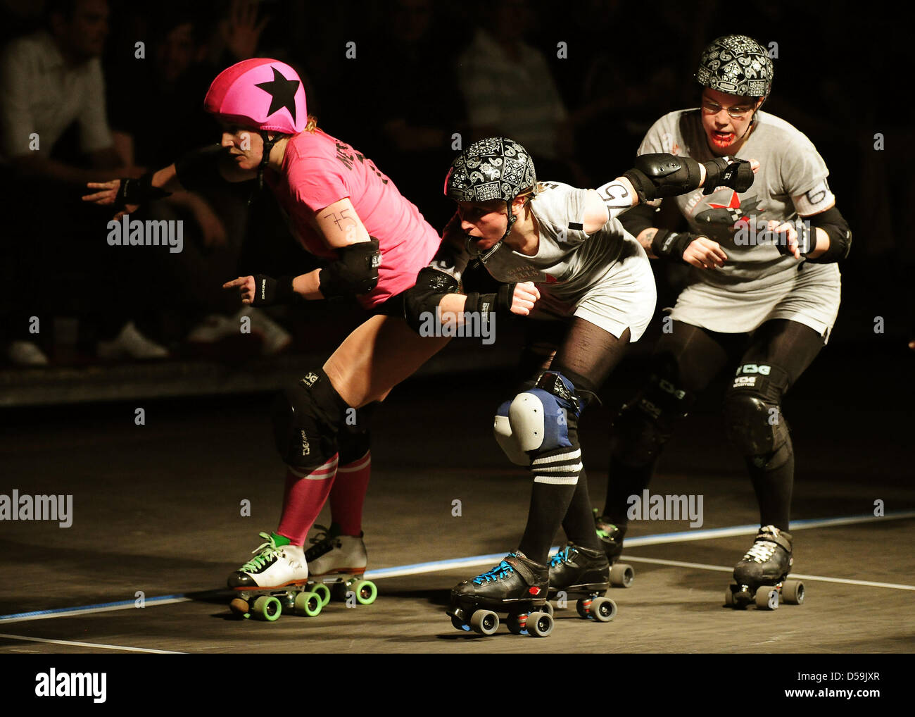 Female roller derby players of the 'Berlin Bombshells' (grey) and the  London team 'Brawl Saints' (pink) compete in Berlin, Germany on 26 June  2010. Roller derby is a full contact sport from
