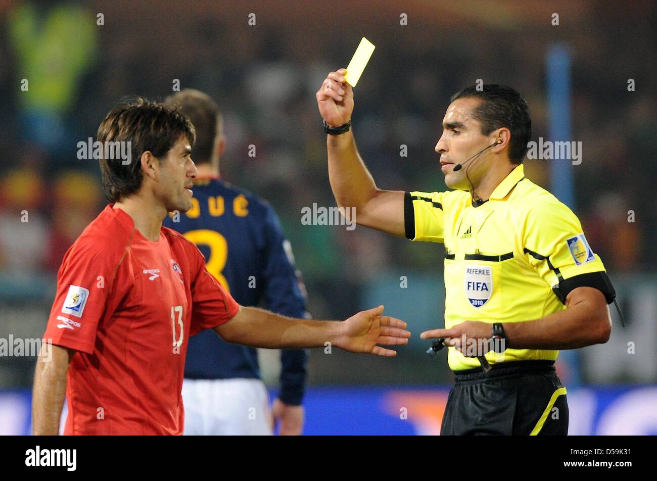 Chile's Marco Estrada is booked with the yellow card by Mexican referee Marco Rodriguez during the 2010 FIFA World Cup group H match between Chile and Spain at Loftus Versfeld Stadium in Pretoria, South Africa 25 June 2010. Photo: Marcus Brandt dpa - Please refer to http://dpaq.de/FIFA-WM2010-TC Stock Photo