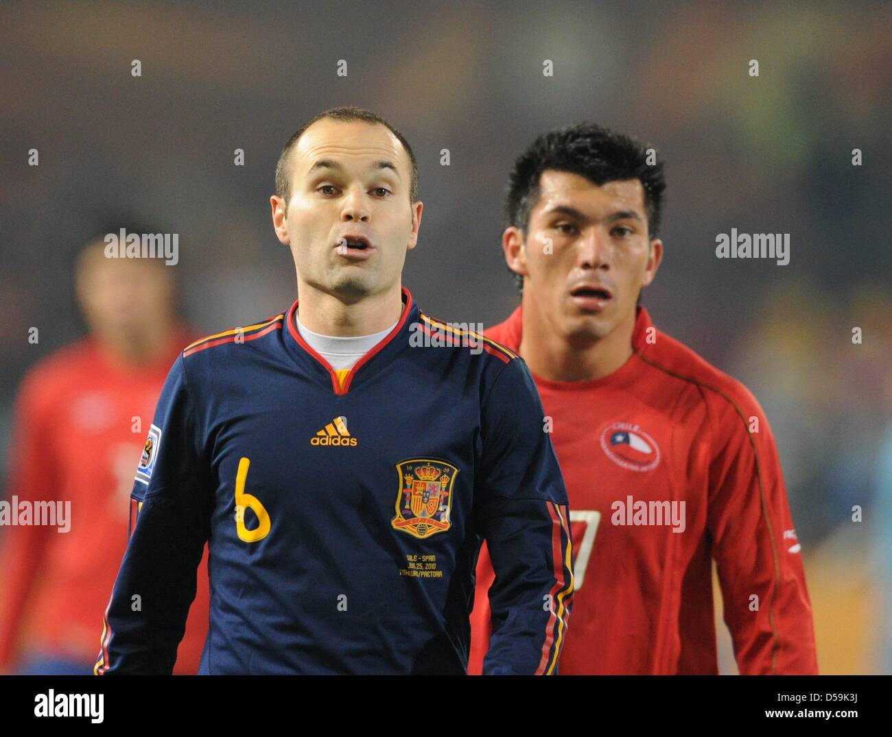Spain's Andres Iniesta (L) stands next to Chile's Gary Medel during the 2010 FIFA World Cup group H match between Chile and Spain at Loftus Versfeld Stadium in Pretoria, South Africa 25 June 2010. Photo: Marcus Brandt dpa - Please refer to http://dpaq.de/FIFA-WM2010-TC Stock Photo