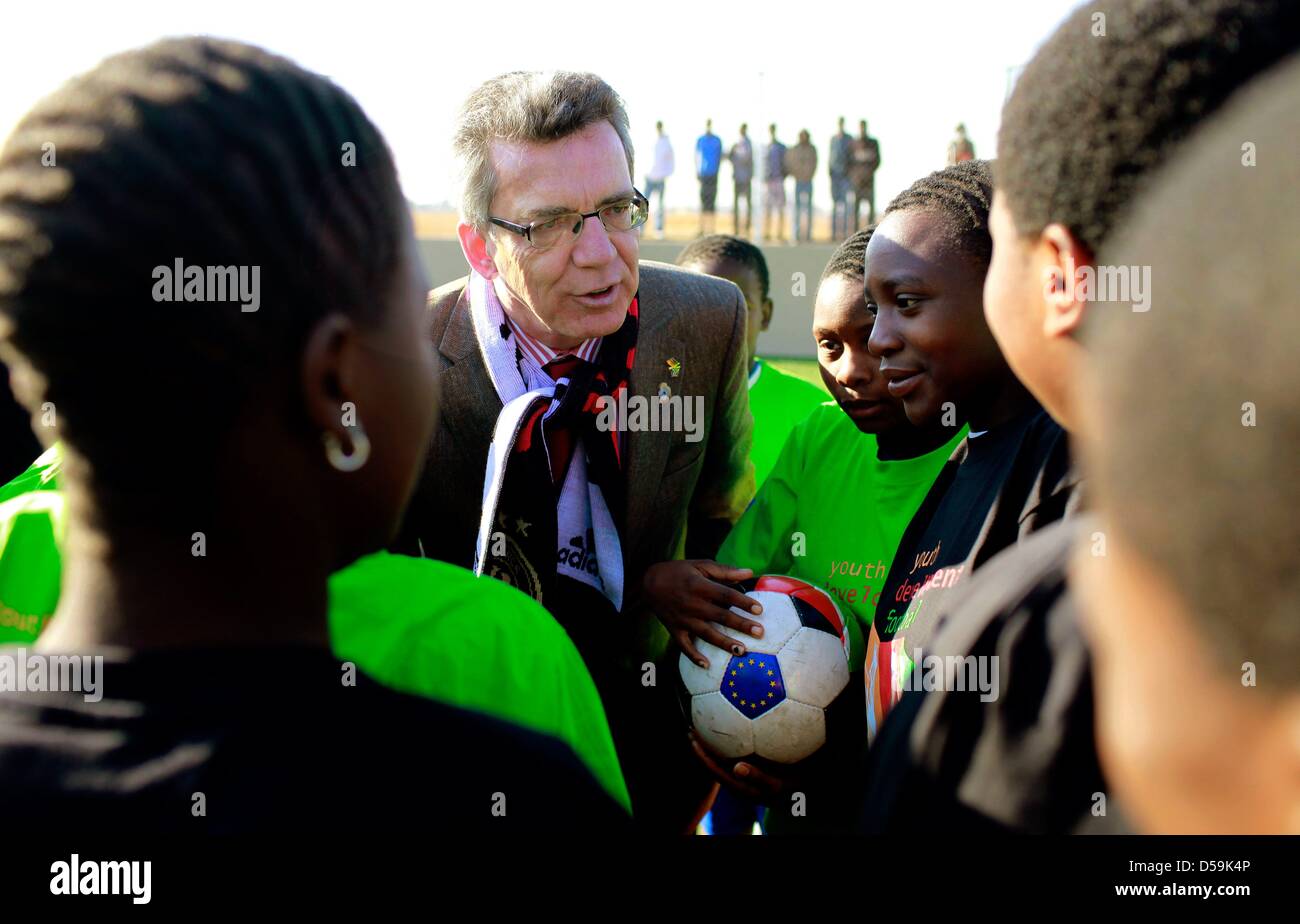 German interior minister Thomas de Maiziere chats with young South African football players during the opening of a football pitch at the Orange Farm township, about 30km south of Johannesburg, South Africa on 27 June 2010. De Maiziere is on a three-day visit to South Africa. Photo: Kerim Okten  +++(c) dpa - Bildfunk+++ Stock Photo