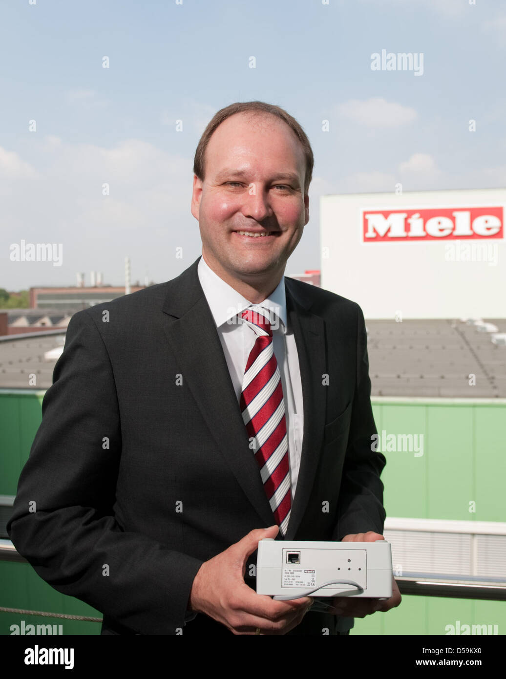 Markus Miele, member of the executive board of the household appliance company Miele, presents electronic accessory devices in Guetersloh, Germany, 25 June 2010. The devices can be used to connect household appliances to the internet via the so-called 'Smart Grid' technology so that the appliances can be controlled from a smartphone. At a press conference, the family business annou Stock Photo